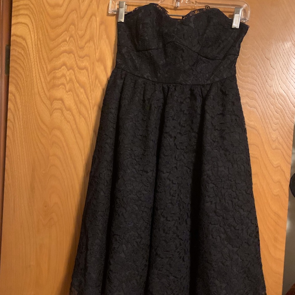 Black knee length sleeveless lace dress with sweetheart neckline